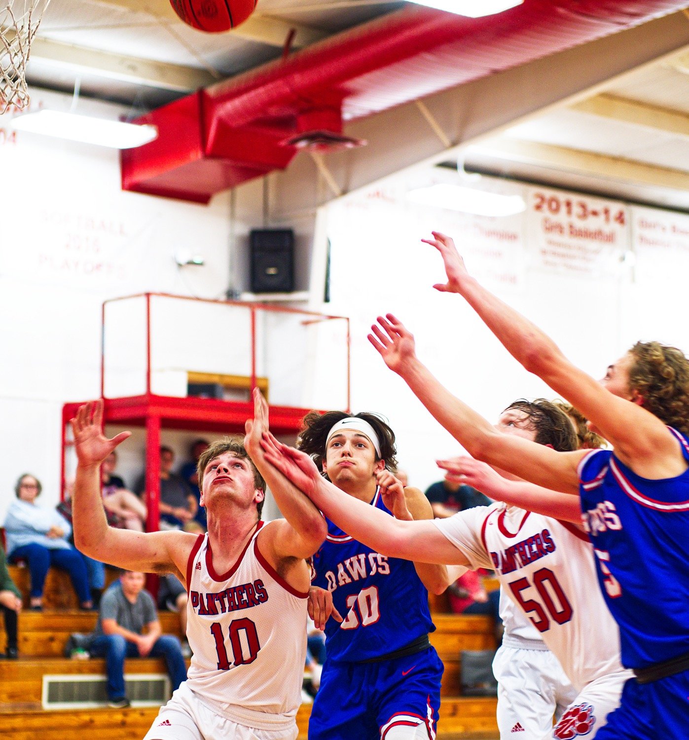 From left, Blake Weissert, Thomas Sebedra, Gavin Dailey and Brady Floyd fight for position to nab a rebound. [catch more of the cross-county hardcourt contest captured]